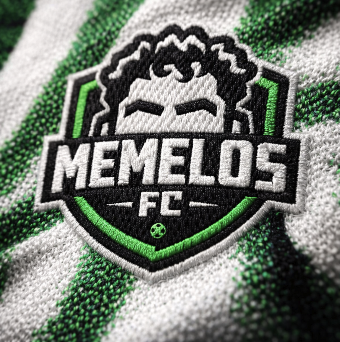 Embroidered Memelos FC crest on the knit jersey fabric