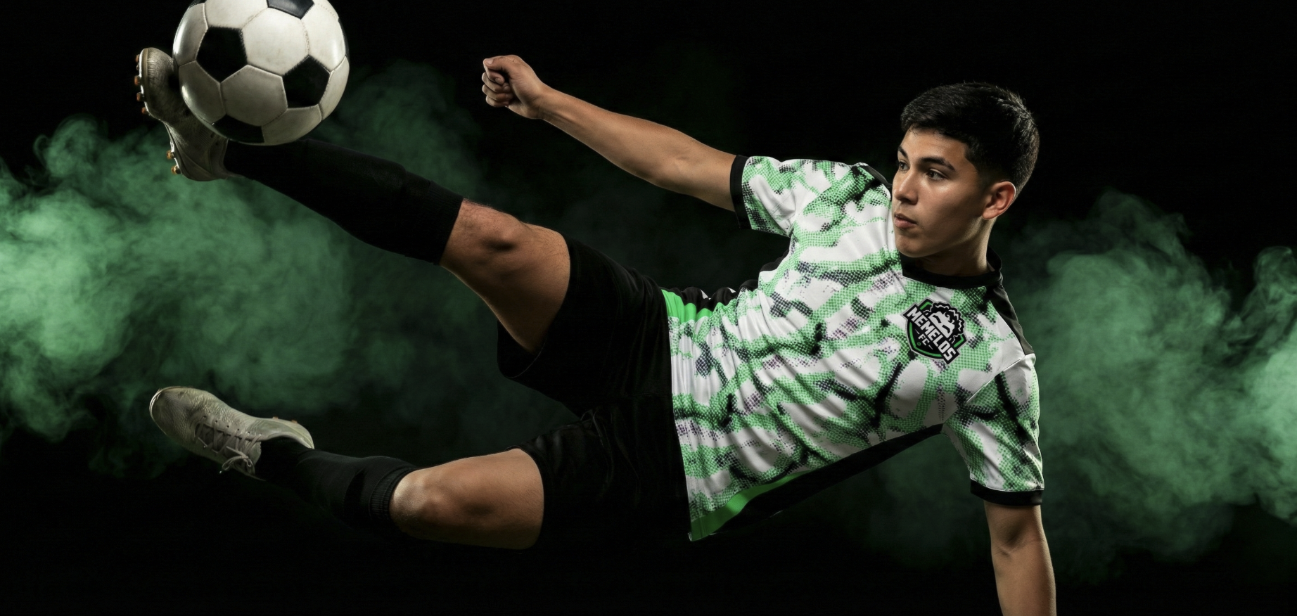 Memelos FC player performing a bicycle kick in green smoke