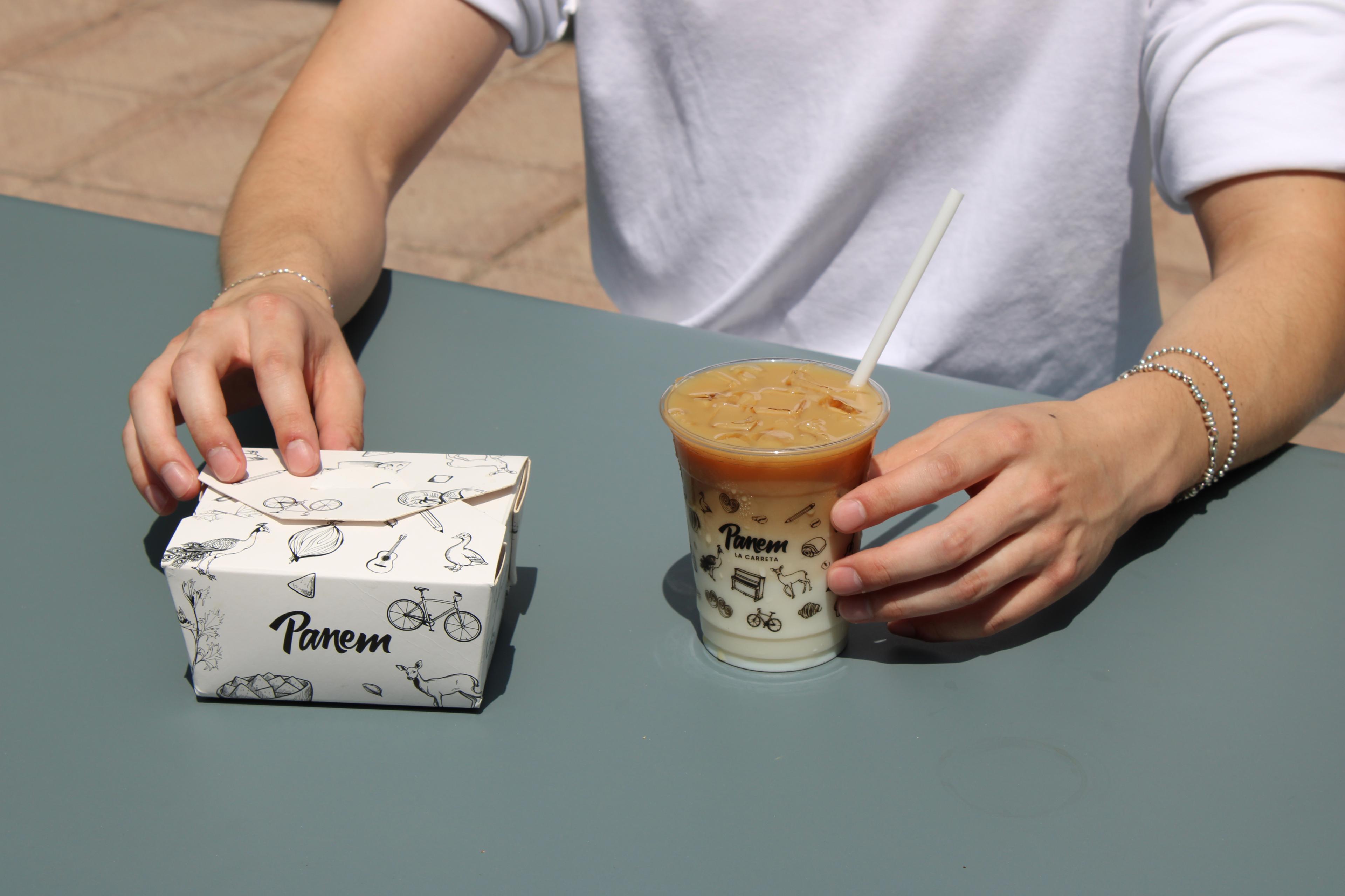 Panem takeout box and iced coffee shared across a table