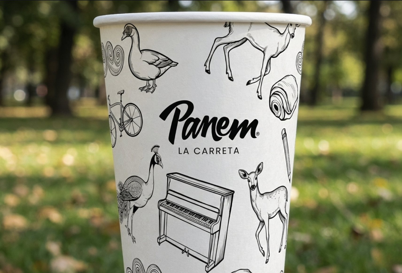 Close-up of an illustrated Panem La Carreta cup held outdoors